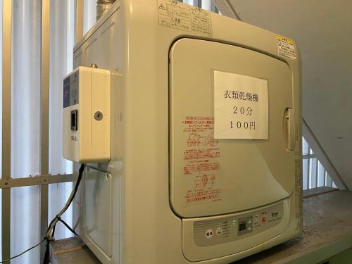 an old refrigerator with a sign on the door at Asahi21 Asahibashi-Ekimae in Naha