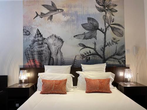 Postel nebo postele na pokoji v ubytování Hôtel Neptune