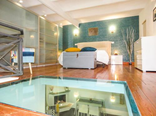 a bedroom with a pool in the middle of a room at Casa del Moro - romantic loft in Trastevere in Rome