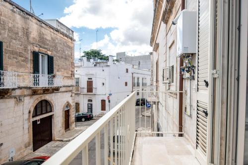 an alley in an old city with white buildings at Le Bianche Suites Ostuni in Ostuni