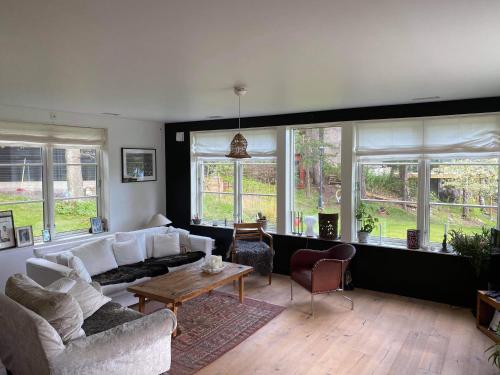 a living room with a couch and a table at Villa Myttinge in Värmdö