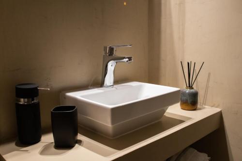 a sink in a bathroom with a faucet at Langi Apartments in Mesolongion