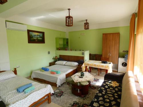 a living room with two beds and a couch at Guesthouse Aleksander in Berat