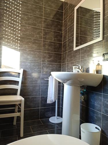 a bathroom with a sink and a mirror at LE MURA Foresteria in Grassobbio