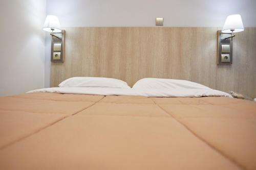 Ένα ή περισσότερα κρεβάτια σε δωμάτιο στο Amalia City Rooms