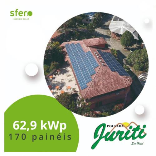 a picture of a house with solar panels on the roof at Pousada Juriti - Eco Hotel in São Roque