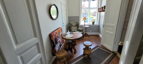 a hallway with a table and a dog standing next to a door at Svea hotell, Vollsjö in Vollsjö