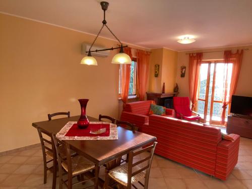 a living room with a table and a red couch at A CASA MIA in Sperlonga