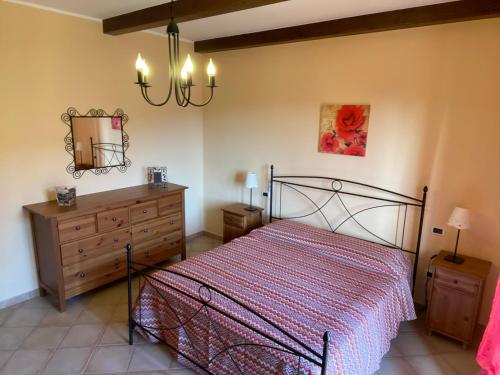 a bedroom with a bed and a dresser and a mirror at A CASA MIA in Sperlonga