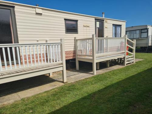 a white rv with two decks on the grass at Sealands Ingoldmells 6 Berth Panel heated Baysdale in Ingoldmells