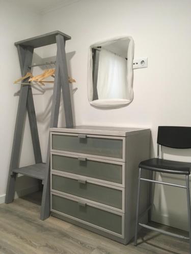 a dressing room with a dresser and a mirror at Capuchos Terrasse in Caparica
