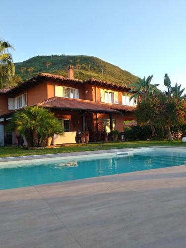 a house with a swimming pool in front of it at B&B Villa Di Giorgi in Cefalù