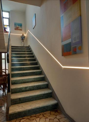 a staircase in a house with a painting on the wall at Hotel Serafini Misano Adriatico in Misano Adriatico