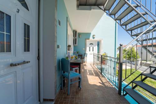 a porch with a table and chairs on a balcony at Belleza Villa in Lixouri