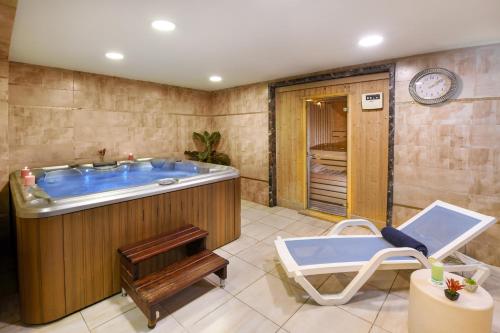 a bathroom with a tub and a sink at Tolip El Galaa Hotel Cairo in Cairo