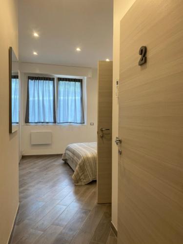 a bedroom with a bed and a window and a door at Affittacamere La Riviera in Levanto