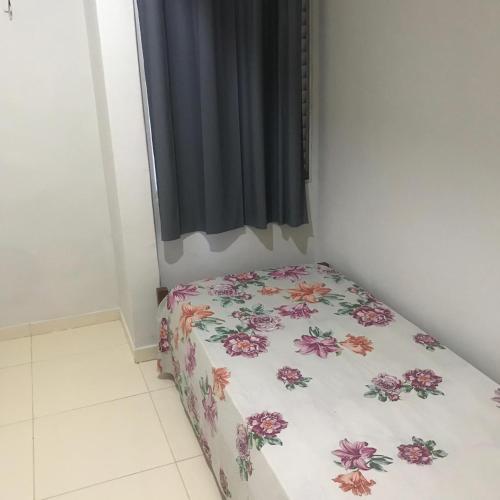a small bed in a room with a curtain at Ed. Oliveiro Lucena in João Pessoa