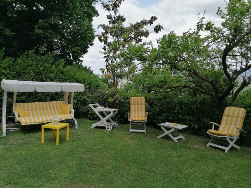a group of chairs and a gazebo in the grass at Residenza Le Ortensie in Todi