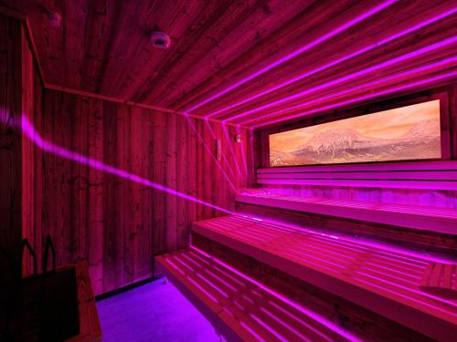 a room with purple lights on the walls at Hotel Lärchenhof in Lermoos