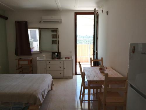 a bedroom with a bed and a table and chairs at El Paso in Castro di Lecce