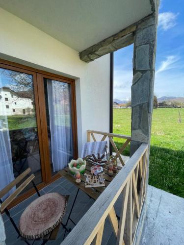 a balcony with a table and a chair and a window at Vila Montenegrina in Kolašin