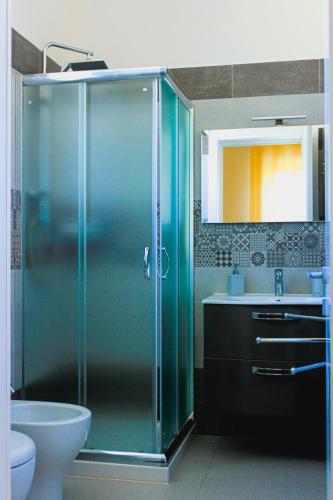 a bathroom with a glass shower and a sink at Armonia Galeta in Nardò