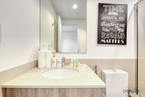 a bathroom with a sink and a mirror at Charismatic 1BR at UNA Town Square Dubailand by Deluxe Holiday Homes in Dubai