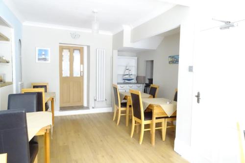 a dining room with a table and chairs at The Melville in Brixham