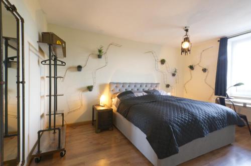 a bedroom with a bed with a black comforter at Ferienwohnung LOFT STUDIO ANNABERG in Annaberg-Buchholz