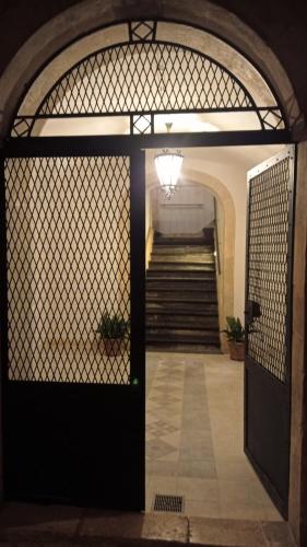 a gate leading to a stairway with a staircase at San Domenico Casa Vacanze in Modica