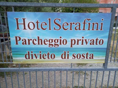 a sign on a gate at the beach at Hotel Serafini Misano Adriatico in Misano Adriatico