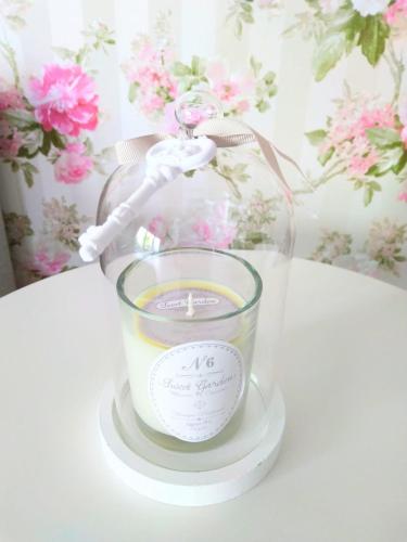 a candle in a glass jar on a table at Romantic Style Apartment Titisee-Neustadt in Titisee-Neustadt