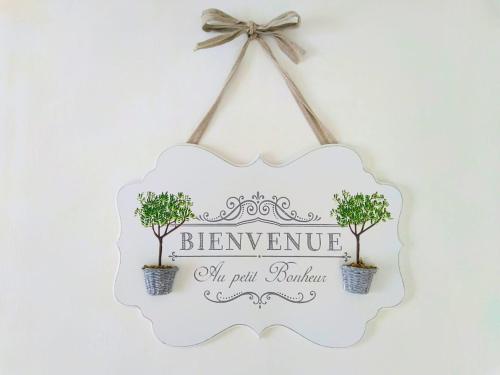 a sign hanging on a wall with two trees at Romantic Style Apartment Titisee-Neustadt in Titisee-Neustadt