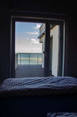 a bedroom with a bed and a view of the ocean at nautica lux apartamenty in Giżycko