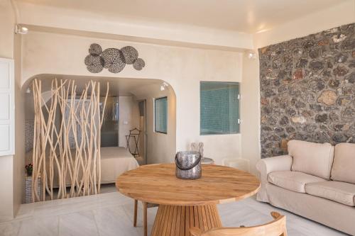a living room with a table and a couch at Armeni Luxury Villas in Oia