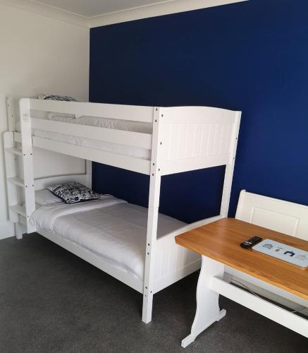 a room with two bunk beds and a table at The Sunfold in Weston-super-Mare