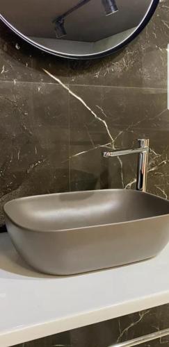a sink sitting on a counter in a bathroom at Hotel Ambasador Garden in Lezhë
