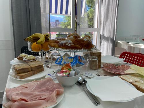 a table with a bunch of bread and pastries on it at Maison De luxe in Pompei