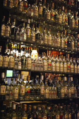a room filled with lots of bottles of alcohol at Oneiro Suites in Souda