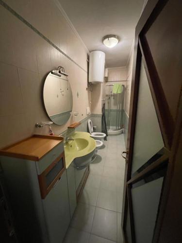 La salle de bains est pourvue de 2 lavabos, d'un miroir et de 2 toilettes. dans l'établissement MAK Apartments, à Tirana