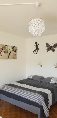 - une chambre avec un lit aux papillons sur le mur dans l'établissement Studio Naturiste 