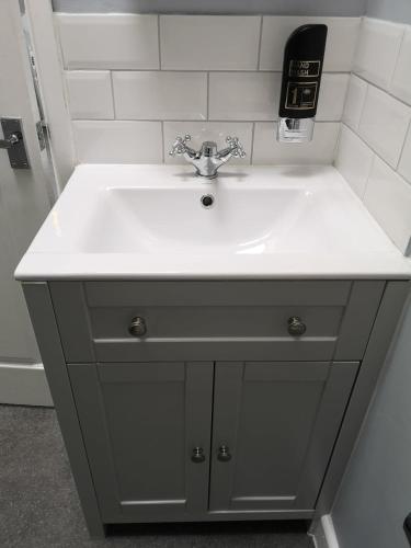 a bathroom sink with a white counter top at The Sunfold in Weston-super-Mare