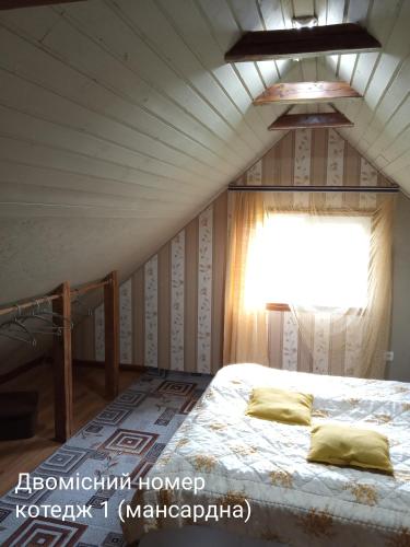 a bedroom with a bed and a window at Pidkova in Verkhovyna