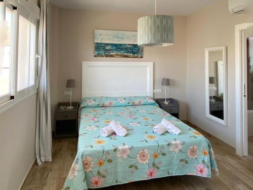 a bedroom with a bed with two pillows on it at Mda Playa del Cantal in Mojácar