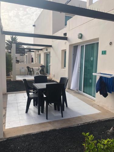 a patio with a table and chairs on a patio at Alisios Dream in Corralejo