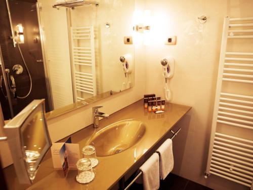 a bathroom with a sink and a large mirror at Grand Hotel Portoroz 4* superior – Terme & Wellness LifeClass in Portorož