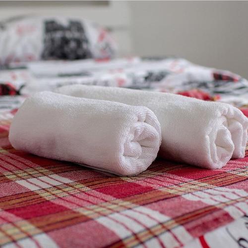 two rolled up towels sitting on top of a table at Hotel 7 in Kapchagay