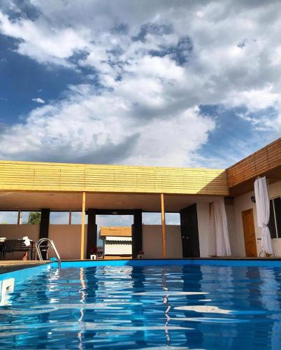 a large swimming pool in front of a building at Hotel 7 in Kapchagay