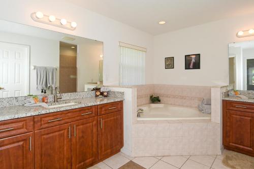 a bathroom with a tub and a sink at Foxrun Terrace Luxury 5BR Pool Villa in Inverness