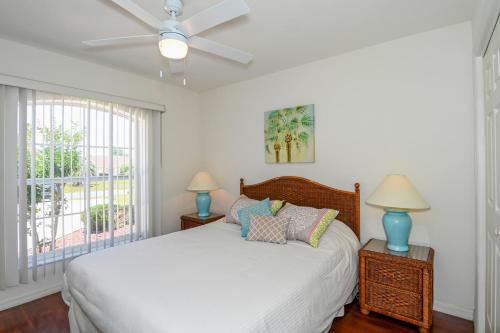 a bedroom with a bed with two lamps and a ceiling fan at Foxrun Terrace Luxury 5BR Pool Villa in Inverness